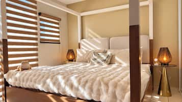 A modern bedroom with a large bed, wooden headboard, and two bedside lamps.