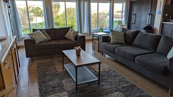 Villa | Living area | 65-inch flat-screen TV with cable channels