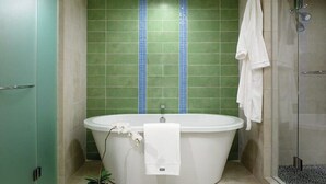 A bathroom with a freestanding bathtub, a glass shower enclosure, and a green tiled wall with a blue border. - Beautiful St John Westin Villa - 2 bedroom Bay Vista (Cruz Bay)