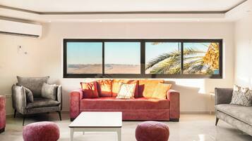 Villa | Living area | 40-inch flat-screen TV with cable channels