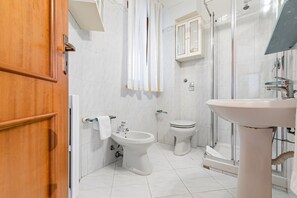 Een douche, een haardroger, een bidet, handdoeken
