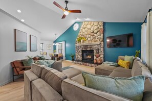 Smart TV, lareira, livros, aparelho de som