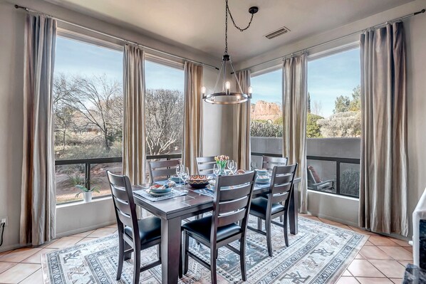 Enjoy meals in this dining area with a table for four, surrounded by comfortable chairs and a beautiful view.