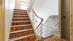 A staircase with wooden steps and a metal railing. - Lisbon Typical by Homing (Lisbon)
