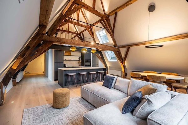 Elegant living space with exposed wooden beams and high ceilings