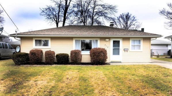 A single-story house with a front yard, a garage, and a satellite dish. - Pet-Friendly Berea 3BR | Fenced Yard | Near CLE (Berea)