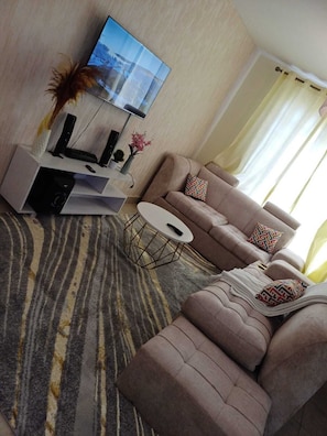 Deluxe Apartment | Living area | 24-inch Smart TV with digital channels
