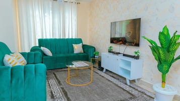 Appartement Affaires | Coin séjour | TV connectée de 24 pouces avec chaßnes numériques