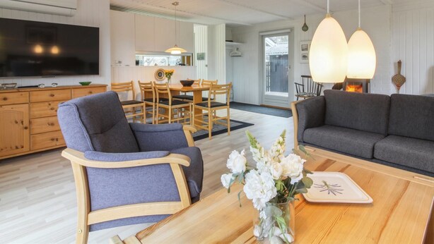 A modern living room with a sofa, armchairs, a coffee table, and a TV. - "Florencia" - 450m from the sea by Interhome (Løkken)