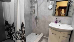 A bathroom with a shower, sink, and mirror. - Best Location, Cozy Spacious Apart Near Republic (Yerevan)