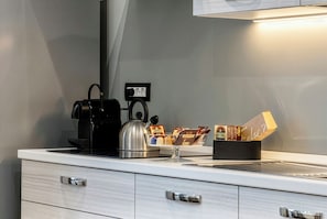 A kitchenette with a coffee maker, kettle, and a coffee pod holder. - Signature Design & Panoramic Views | Montecatini Terme (Montecatini Terme)