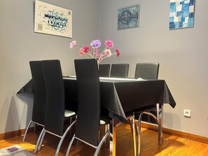 A conference room with a table, chairs, and floral decorations.