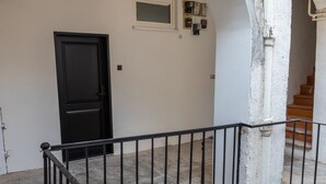A staircase with a black railing leading to a landing. - Candy Cavalier Zagreb Center Lux (Zagreb)