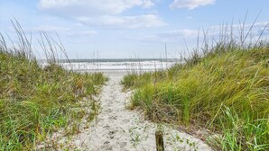A sandy path leading to a beach with grassy dunes on either side. - 10% off 3-7 nights thru Oct. A BEAUTY! Oceanfront 3 bedroom. Sleeps 6. Outdoor pool (North Myrtle Beach)