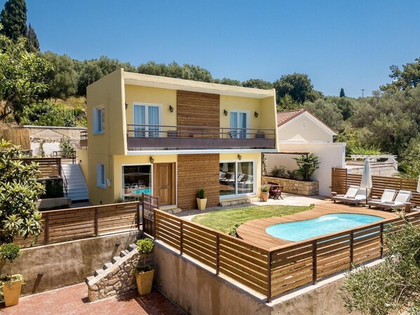 A two-story house with a swimming pool, wooden deck, and a view of the surrounding landscape. - Diogenis Villa Kefalonia (Kefalonia)