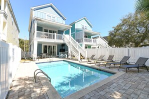 A two-story house with a swimming pool, outdoor furniture, and a white fence. - 5 BR Beach House with a Private Pool! Above The Tiki Hutt (Surfside Beach)