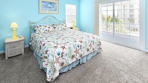 A bedroom with a bed, two bedside tables, a window, and a balcony view. - 4 BR 2nd Row Beach House with a Private Pool! Beachy Keen (Surfside Beach)