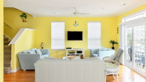 A living room with a sofa, armchairs, a television, and a ceiling fan. - 4 BR 2nd Row Beach House with a Private Pool! Beachy Keen (Surfside Beach)