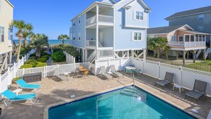 A two-story building with a pool and outdoor seating area. - Oceanview 5 BR Beach House with a Private Pool! Blue Lagoon A (Surfside Beach)