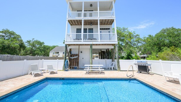 A two-story building with a pool, outdoor seating, and a barbecue area. - 4 BR Beach House with a Private Pool! It's A Stone Harbor Thing (Surfside Beach)