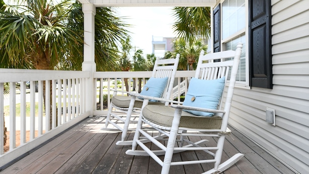 A porch with two rocking chairs, white railings, and a view of palm trees. - 2nd Row 5 BR Beach House with a Private Pool! Sale Away (Surfside Beach)