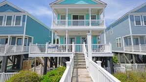 A two-story house with a balcony, wooden deck, and a small porch. - Oceanfront 5 BR Beach House with a Private Pool! La Dolce Vita (Surfside Beach)
