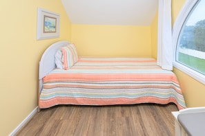 A bedroom with a bed, a window, and a picture on the wall. - 3 BR Beach House in Surfside Beach with Shared Pool!  Sea Bridge 1015 (Surfside Beach)