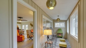 A hallway with patterned flooring, a green lamp, and a fireplace. - Vintage Coloma Home w/ Deck: Shop, Swim & Dine! (Coloma)