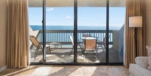 A hotel balcony with a view of the ocean, a table with chairs, and a sofa. - Century One-2 Bedroom Ocean Oasis with Indoor Pool! (Ocean City)