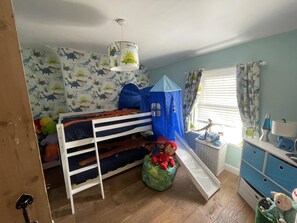 A child's bedroom with a bunk bed, a play tent, and a window with curtains. - Immaculate 3-bed House in Bridgnorth (Bridgnorth)