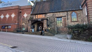 A historic building with a cinema and cafe bar, featuring a brick facade and arched entrance. - Tranquil Apartment in Norwich City Center (Norwich)