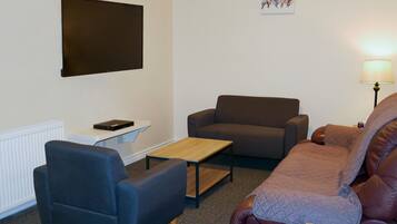 Basic Suite | Living area | 50-inch flat-screen TV with cable channels, streaming services