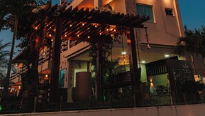 A multi-story building with a balcony and outdoor seating area, likely a hotel or restaurant. - POUSADA SOLLARI (Trairi)
