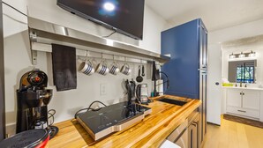 A modern kitchen with a built-in stove, a coffee maker, and a toaster. - Beautiful new studio on the water (New Bern)