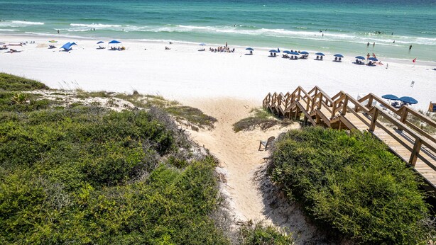 A beach with a wooden boardwalk leading to the shore, surrounded by greenery. - Seagrove "30Astrella Del Mar" |4BR |Private Pool|3min walk to beach access! (Santa Rosa Beach)