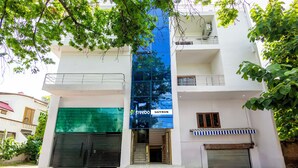 A multi-story building with a glass facade, a sign reading "treebo SAFFRON", and a gated entrance. - Treebo Saffron (Lucknow)