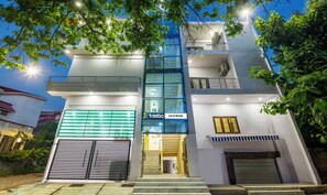 A modern building with a glass facade, a sign for 'treebo Saffron', and a gated entrance. - Treebo Saffron (Lucknow)