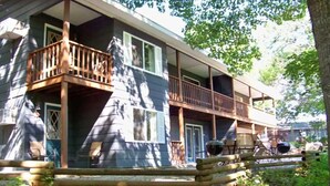 A multi-story building with balconies, wooden railings, and a covered outdoor area. - Tribesman Resort #9 - Renovated Condo, Lake Access, Slip Rental, Great Location! (Branson)