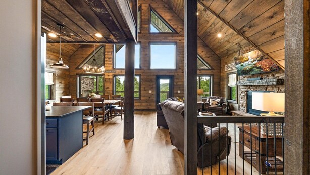A spacious loft with high ceilings, exposed wooden beams, and large windows offering views of the surrounding landscape. - Mountain Cabin - Views, Theater, Game Room, Pool (Sevierville)