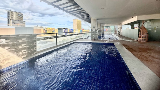 An indoor swimming pool with clear views of the cityscape. - Cebu Rooms- Sunvida Tower (Cebu City)
