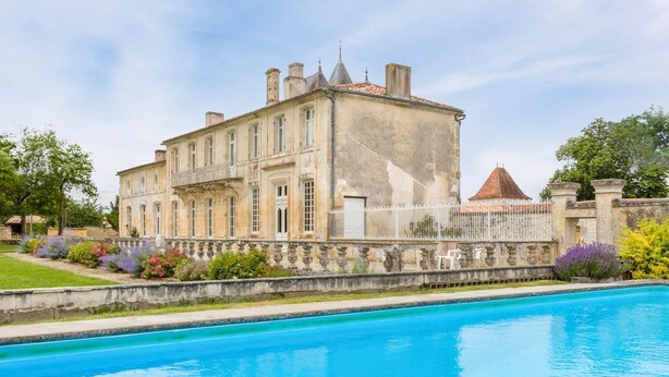 A large, historic building with a swimming pool in front. - Chateau Serbise Estate (Belluire)