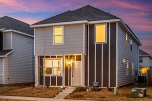 Stunning two-story home with a central entrance and porch.