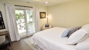 A bedroom with a large bed, a desk, and a chair. - Pet-Friendly Waterfront Retreat w/ Private Dock on Virginia’s Eastern Shore (Exmore)