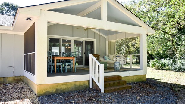 A covered porch with a staircase leading to a seating area with outdoor furniture. - Pet-Friendly Waterfront Retreat w/ Private Dock on Virginia’s Eastern Shore (Exmore)