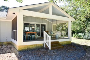 A covered porch with a staircase leading to a seating area with outdoor furniture. - Pet-Friendly Waterfront Retreat w/ Private Dock on Virginia’s Eastern Shore (Exmore)