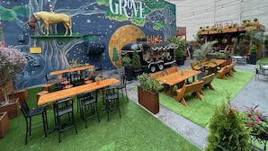 An outdoor dining area with wooden tables and chairs, a mural of a horse and moon, and a food truck labeled "LUNA." - Near KYSHP & Fasig-Tipton
Equestrian & Bourbon Tours Central
The Kingston!! (Lexington)