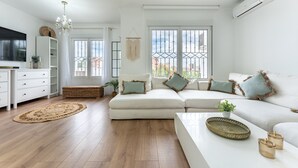 A modern living room with a sofa, a coffee table, and a TV. - Villa 'Casa Ohana' with sea views, Wi-Fi, and air conditioning (Fuengirola)