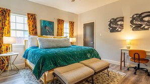 A bedroom with a bed, a desk, a chair, and artwork on the walls. - Southtown 3BR Pool & Playset—Riverwalk—BBQ—Firepit (San Antonio)
