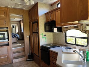 Fridge, microwave, stovetop, cookware/dishes/utensils