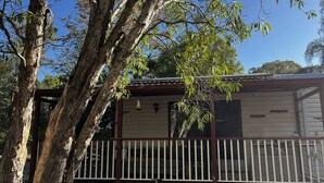 A house with a balcony, surrounded by trees. - Beachmere Dude Ranch (Beachmere)